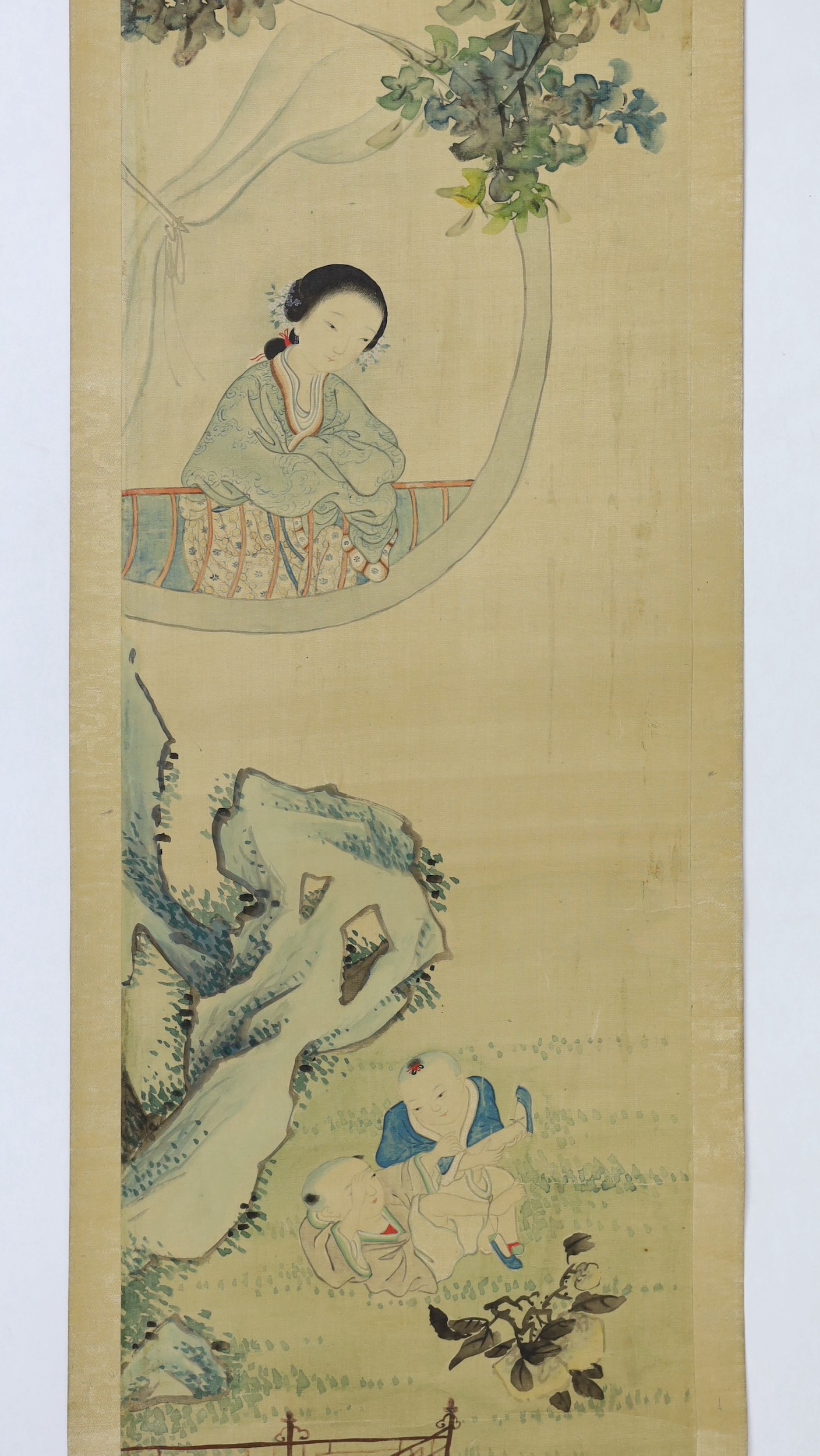 A Chinese scroll painting on silk of a mother watching her children play in a garden, 19th century, image 95cm x 21cm